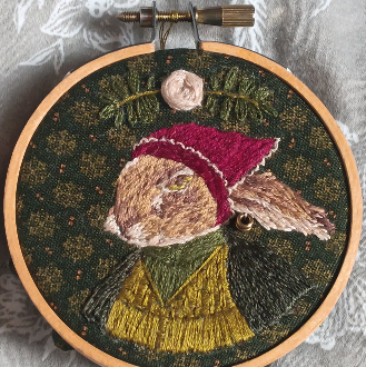 2024 handsewn embroidery of a rabbit in natural colors.
